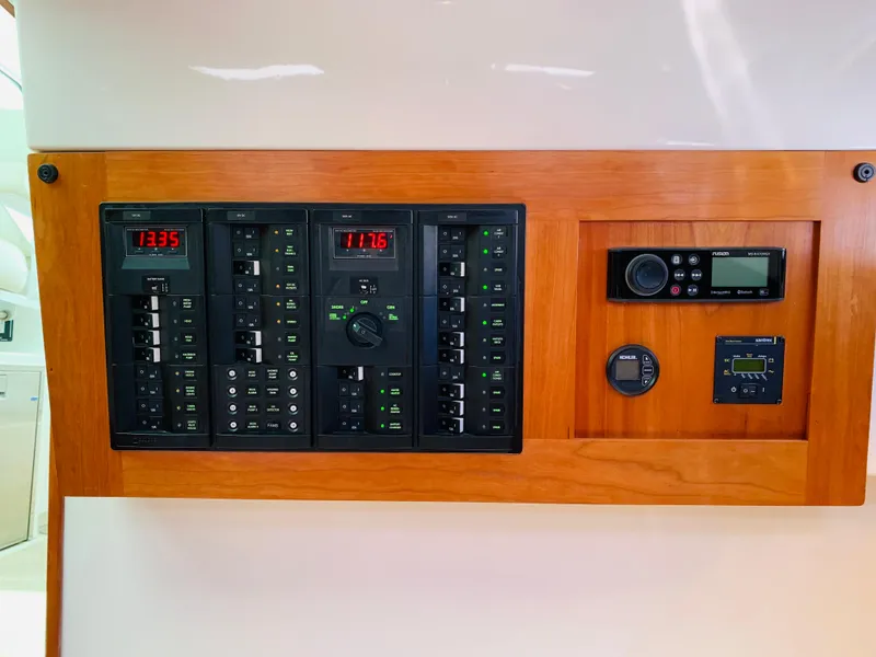 Slide: The Image of Control panel of 2015 Back Cove 34 Express boat with wooden trim. - 27