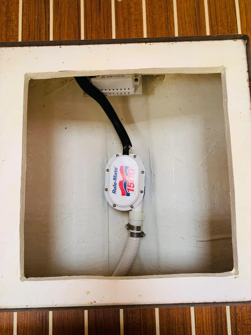 Slide: The Image of Back Cove 34 Express 2015 bilge pump installation on wooden floor. - 28