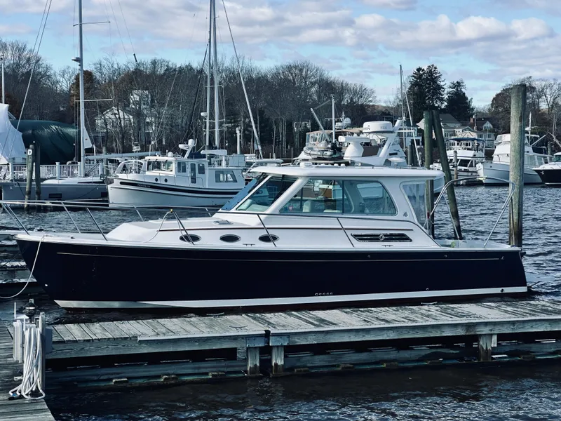 Slide: The Image of 2015 Back Cove 34 Express docked at marina with other boats. - 3