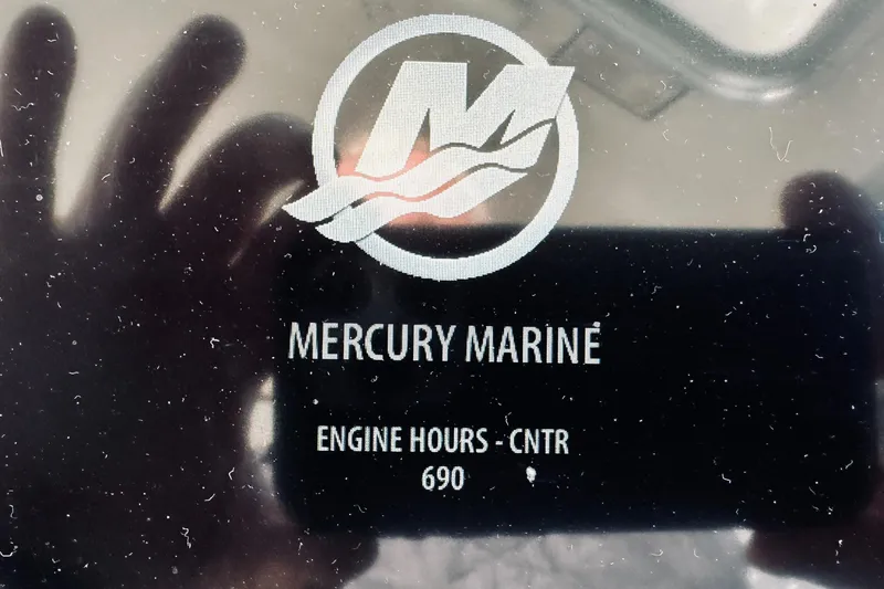 Slide: The Image of Mercury Marine engine display showing 690 hours on Back Cove 34 Express, 2015 model. - 34