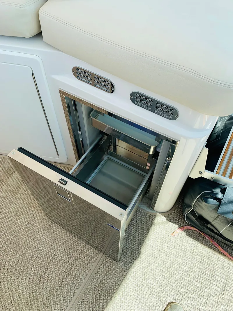 Slide: The Image of 2015 Back Cove 34 Express boat interior with open drawer refrigerator. - 37