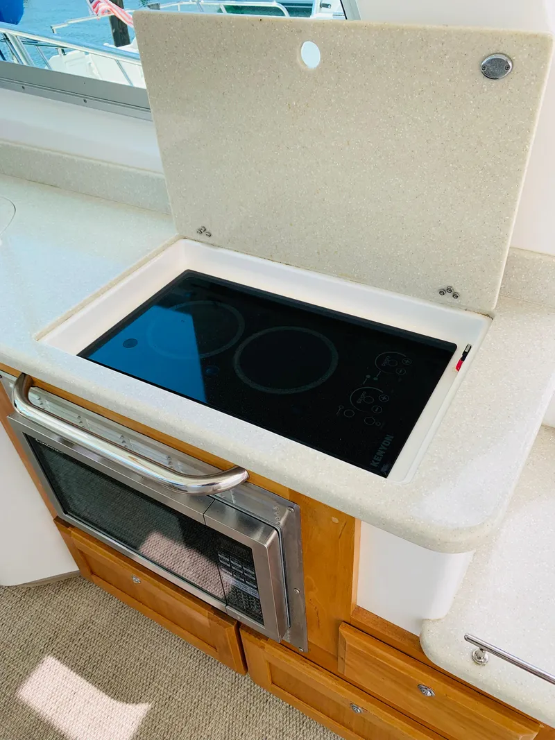 Slide: The Image of 2015 Back Cove 34 Express yacht kitchen with stove and oven. - 42