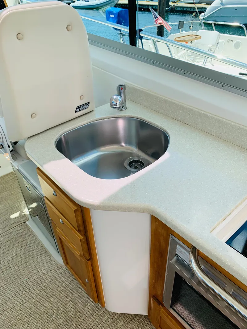 Slide: The Image of 2015 Back Cove 34 Express yacht interior with sink and cabinetry. - 43