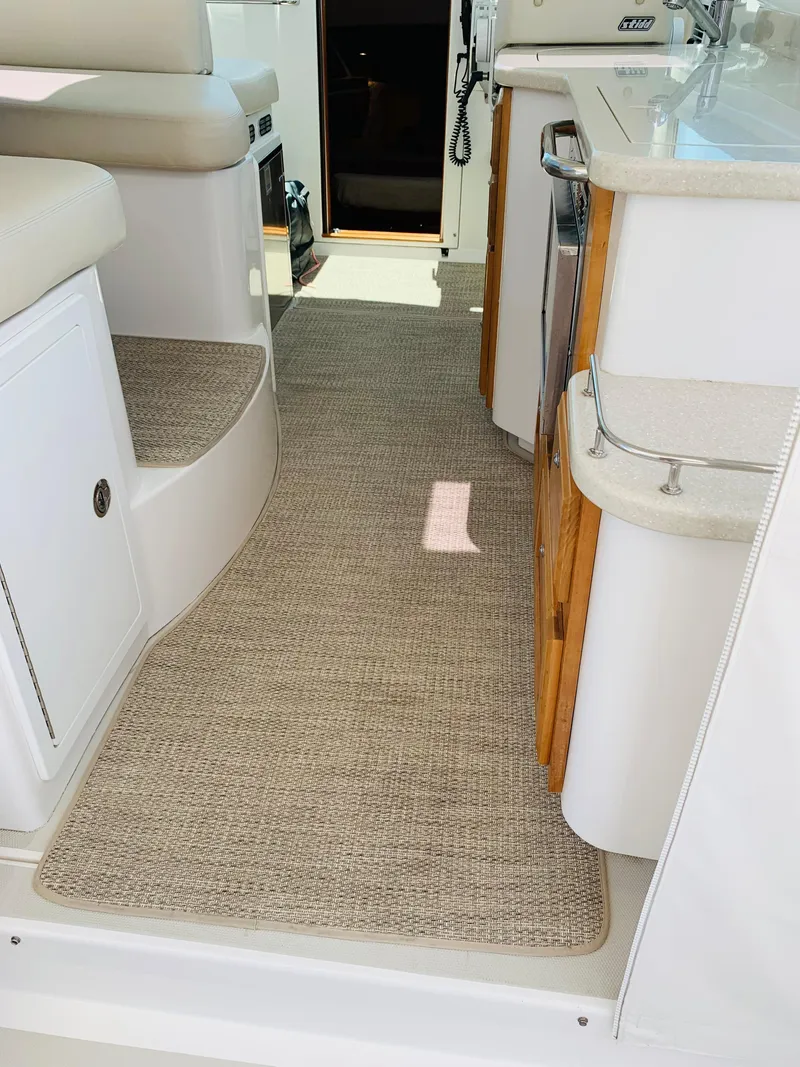 Slide: The Image of Interior of 2015 Back Cove 34 Express yacht with beige carpet and white cabinetry. - 46