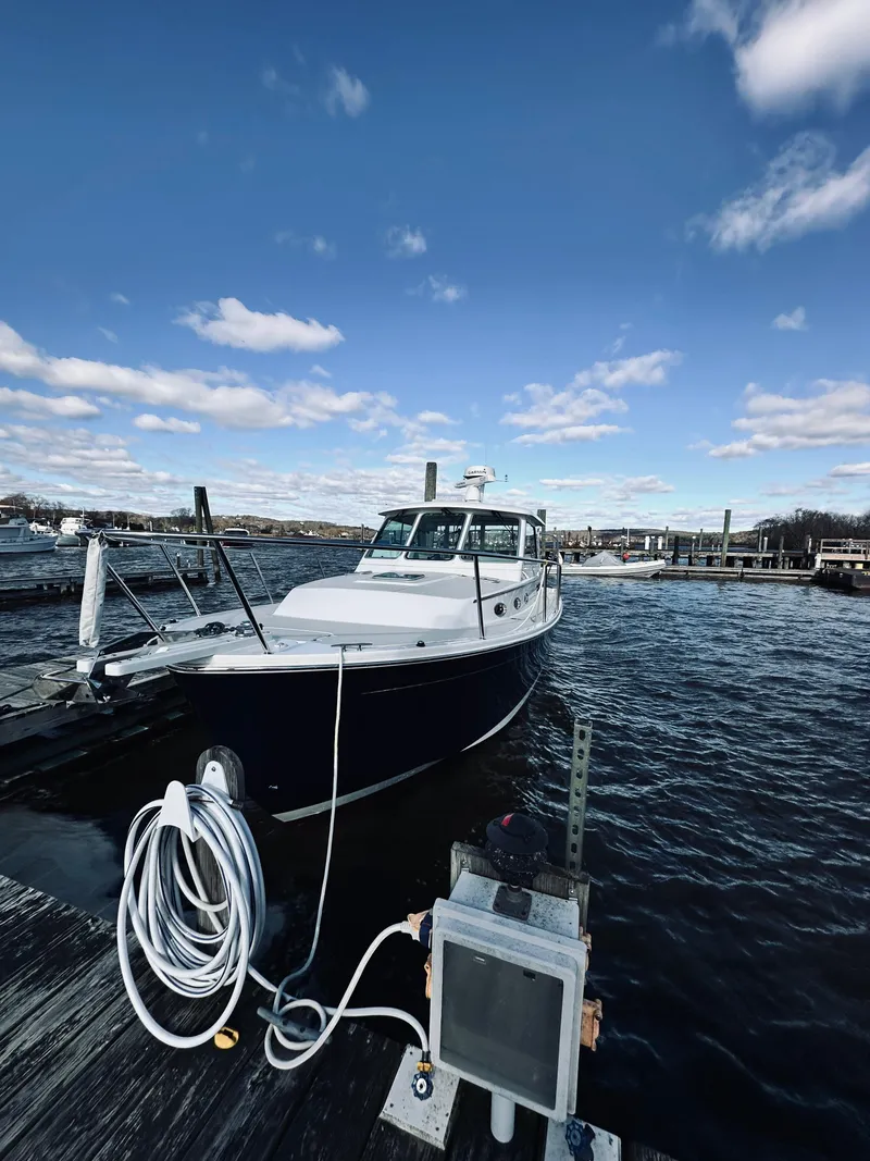 Slide: The Image of 2015 Back Cove 34 Express docked under a clear blue sky. - 5