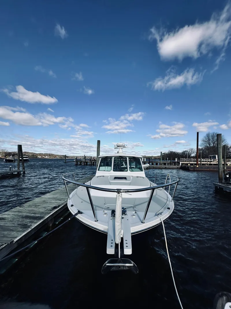 Slide: The Image of 2015 Back Cove 34 Express docked under a clear blue sky. - 6