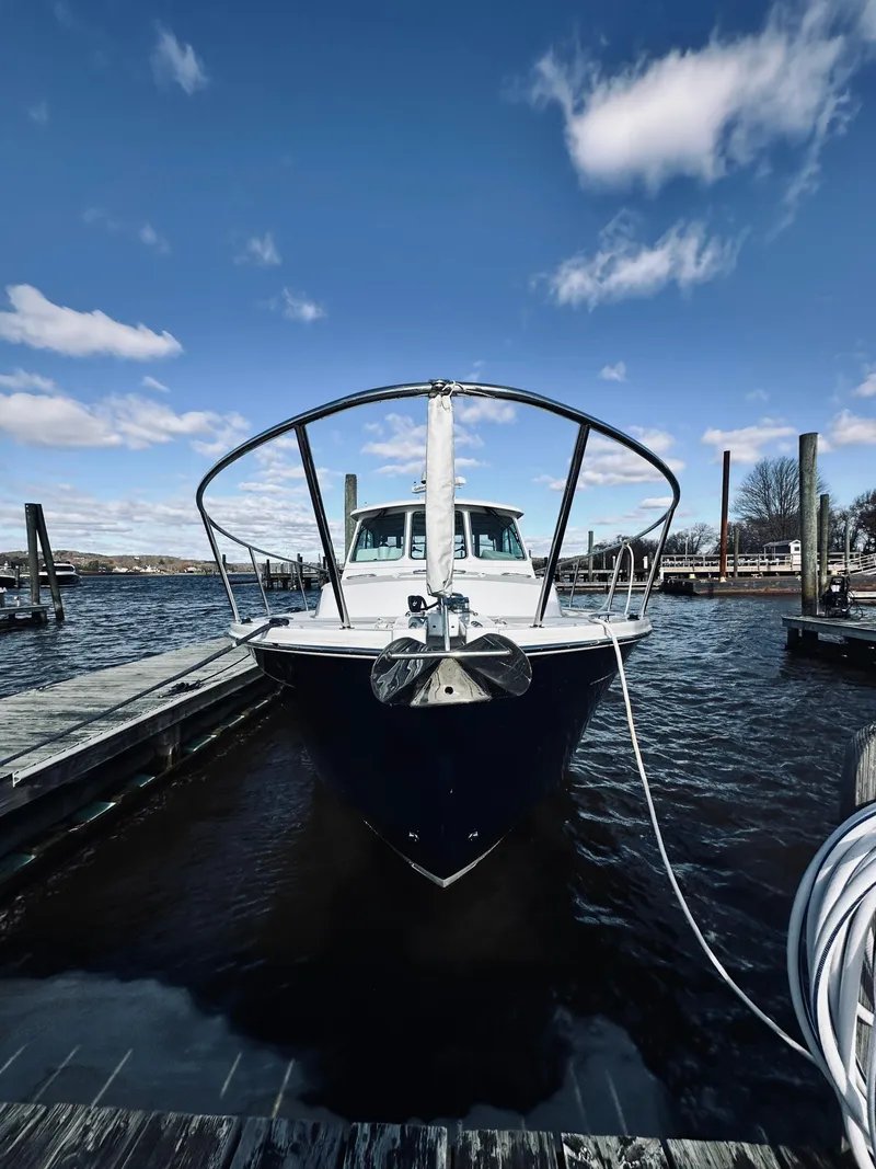 Slide: The Image of 2015 Back Cove 34 Express docked at marina under blue sky. - 7