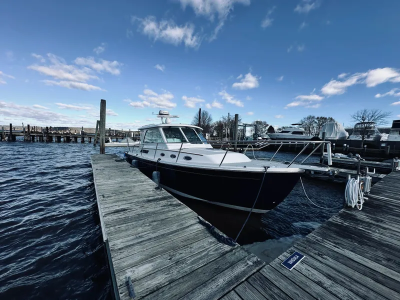 Slide: The Image of 2015 Back Cove 34 Express docked at marina under blue sky. - 8