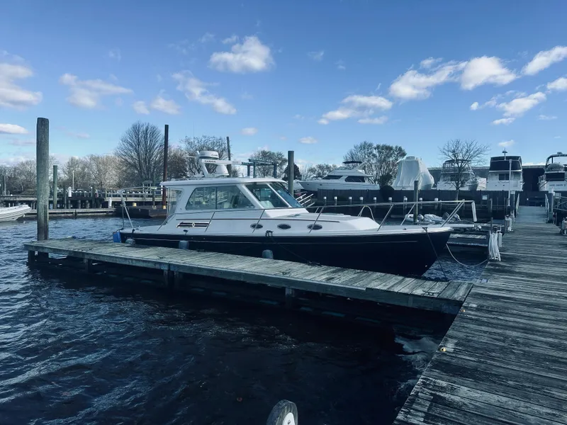 Slide: The Image of 2015 Back Cove 34 Express docked at marina under blue sky. - 9
