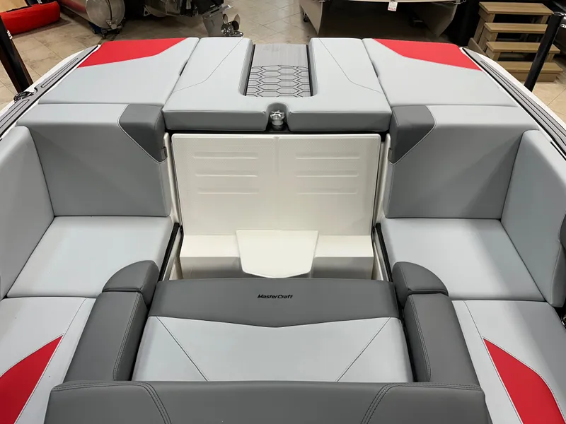 Slide: The Image of 2025 MasterCraft NXT21 boat interior with gray and red seating. - 10