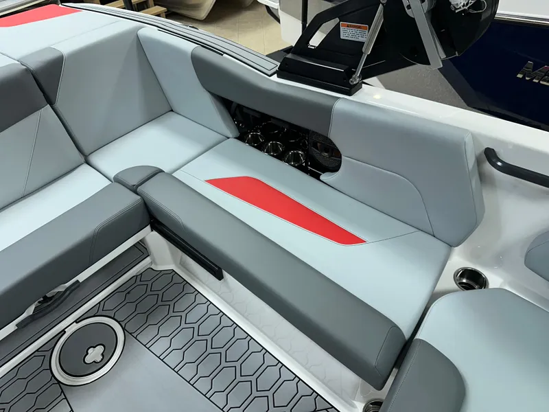 Slide: The Image of 2025 MasterCraft NXT21 boat interior with gray and red seating, hexagonal floor pattern. - 12