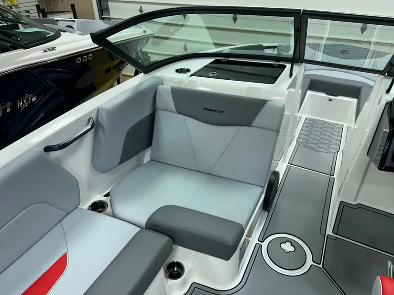 Slide: The Image of 2025 MasterCraft NXT21 boat interior with gray seating and modern design. - 13