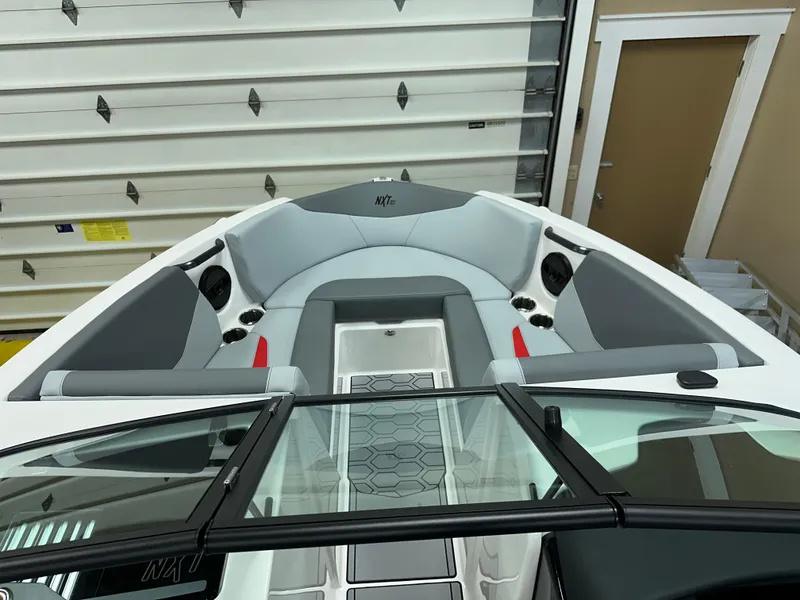 Slide: The Image of 2025 MasterCraft NXT21 boat interior with gray seating and modern design. - 14