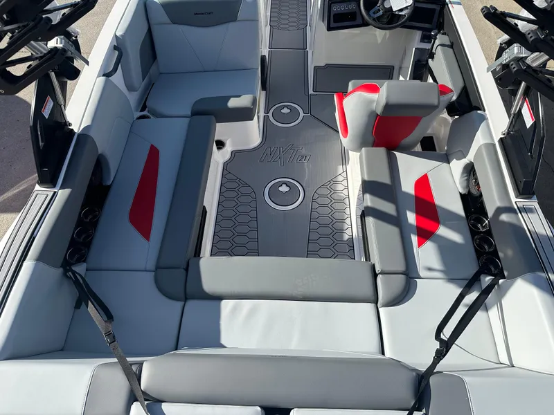 Slide: The Image of 2025 MasterCraft NXT21 boat interior with gray and red seating, modern design. - 4