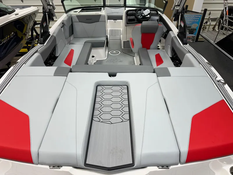 Slide: The Image of 2025 MasterCraft NXT21 boat interior with modern seating and red accents. - 6