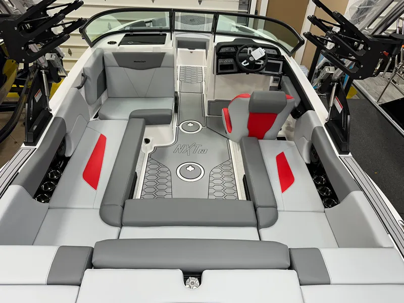 Slide: The Image of 2025 MasterCraft NXT21 boat interior with gray and red seating, modern design. - 7