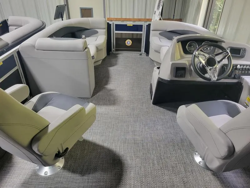 Slide: The Image of Interior of 2025 Barletta A20UC pontoon boat with modern seating and steering console. - 13
