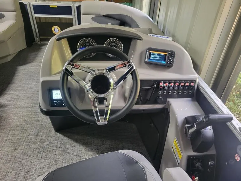 Slide: The Image of 2025 Barletta A20UC boat dashboard with modern steering wheel and control panel. - 9