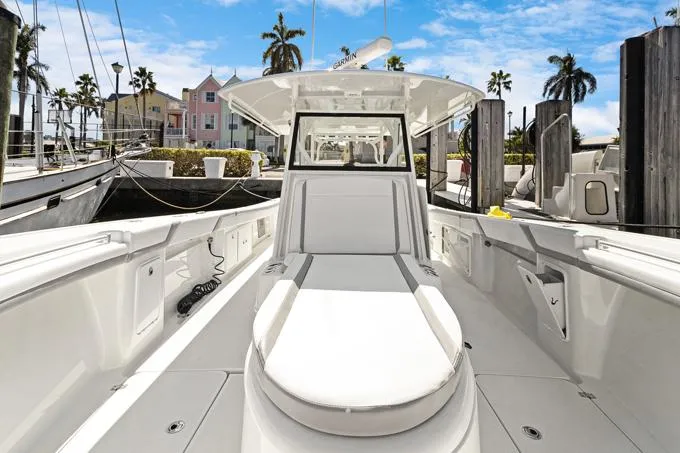 Slide: The Image of 2020 Yellowfin 39 Center Console boat docked in marina, clear sky, palm trees. - 19