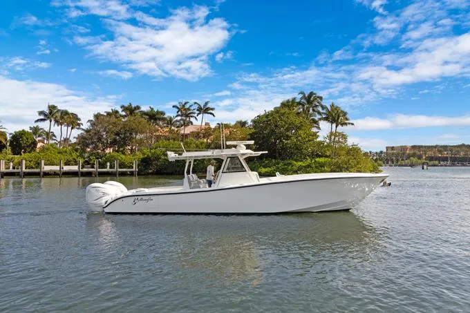 Slide: The Image of 2020 Yellowfin 39 Center Console boat on a scenic waterway with palm trees. - 33