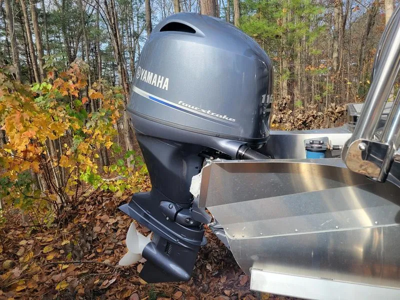 Slide: The Image of Yamaha outboard motor on 2025 Barletta A20UC boat in wooded area. - 6