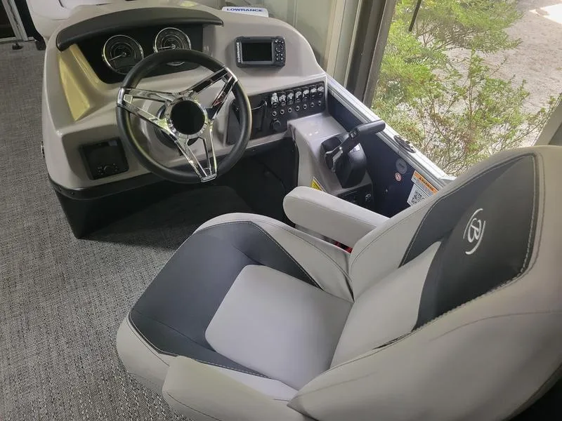 Slide: The Image of 2025 Barletta A20UC boat cockpit with steering wheel and control panel. - 7
