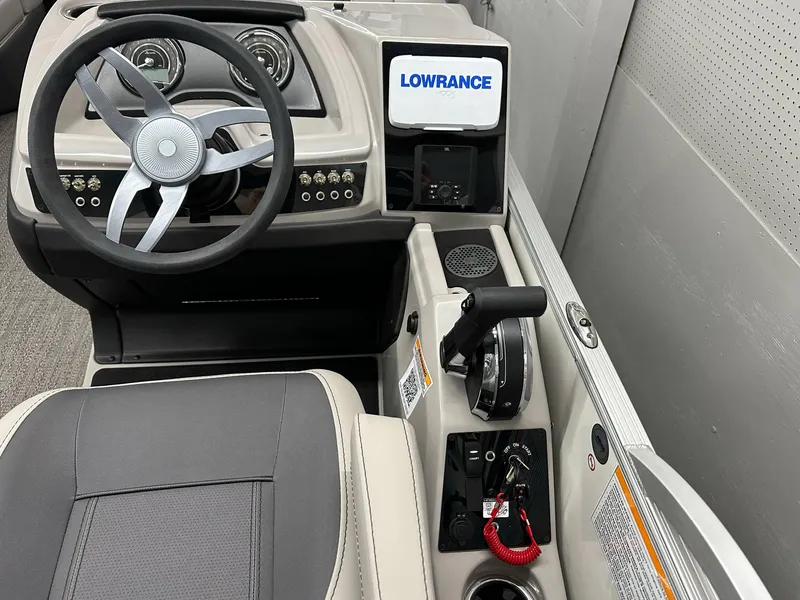 Slide: The Image of 2025 Barletta CABRIO 20QC boat dashboard with steering wheel and Lowrance display. - 11