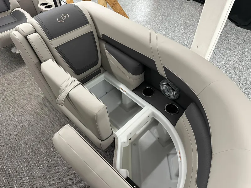 Slide: The Image of 2025 Barletta CABRIO 20QC boat interior with storage, cup holders, and fan. - 13