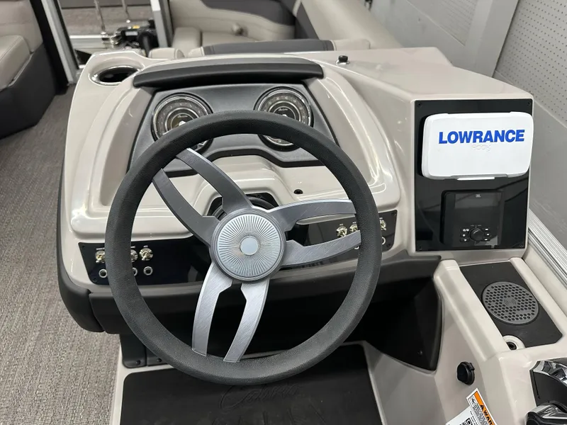 Slide: The Image of 2025 Barletta Cabrio 20QC boat dashboard with steering wheel and Lowrance display. - 8