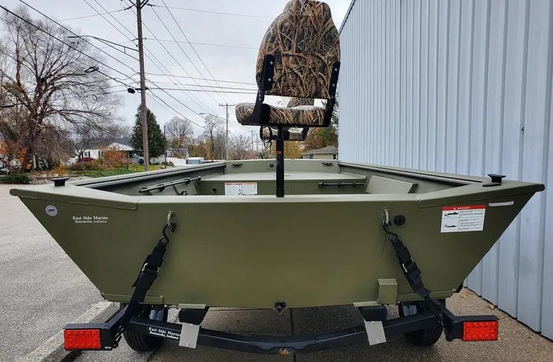 Slide: The Image of Lowe Roughneck RX1660 Tiller 2025 on trailer, green color, outdoor setting. - 4