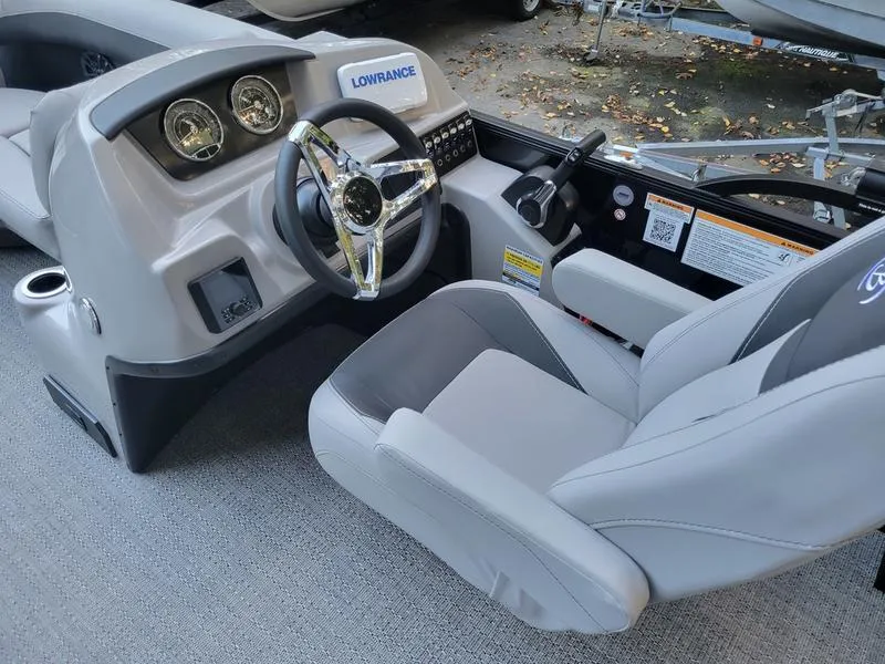 Slide: The Image of 2025 Barletta A20UC boat cockpit with steering wheel and control panel. - 11
