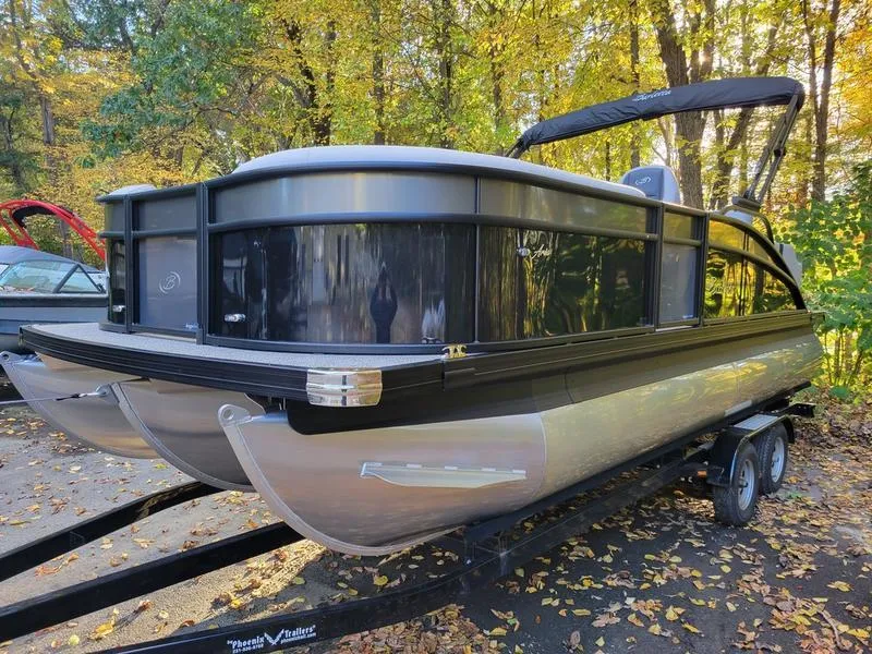 Slide: The Image of 2025 Barletta A20UC pontoon boat on trailer, surrounded by autumn trees. - 3