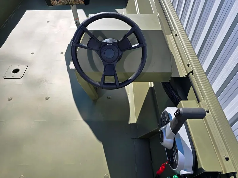 Slide: The Image of 2025 Lowe RX2070 boat with side console steering, featuring a sleek design and modern controls. - 11