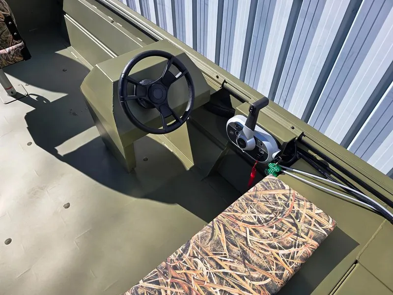 Slide: The Image of Side console steering and snap down camo seat pad. - 2