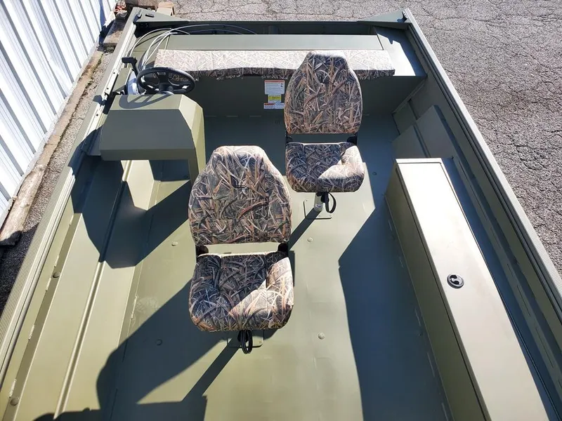 Slide: The Image of 2025 Lowe RX2070 boat interior with camo seats and steering console. - 6