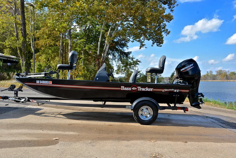 Slide: The Image of 2024 Bass Tracker Classic XL boat on trailer by a lake. - 11