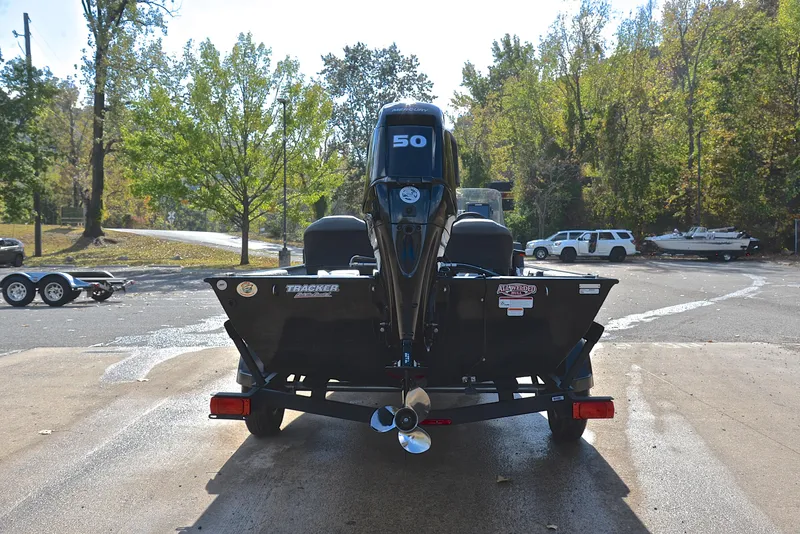 Slide: The Image of 2024 Bass Tracker Classic XL boat on trailer at a lakeside launch. - 13