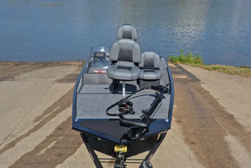 Slide: The Image of 2024 Bass Tracker Classic XL boat at a lakeside launch ramp. - 17