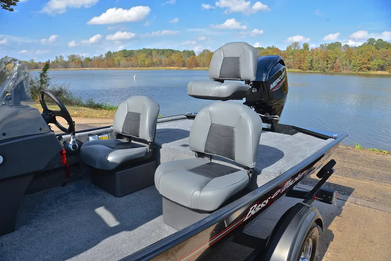 Slide: The Image of 2024 Bass Tracker Classic XL boat with gray seats by a scenic lake. - 18