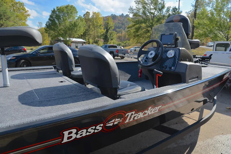 Slide: The Image of 2024 Bass Tracker Classic XL boat with dual seats and control panel, parked outdoors. - 19