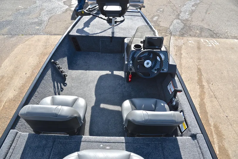 Slide: The Image of 2024 Bass Tracker Classic XL boat interior with seating and steering console. - 20