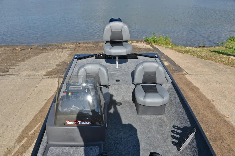 Slide: The Image of 2024 Bass Tracker Classic XL boat interior at a lakeside launch. - 21
