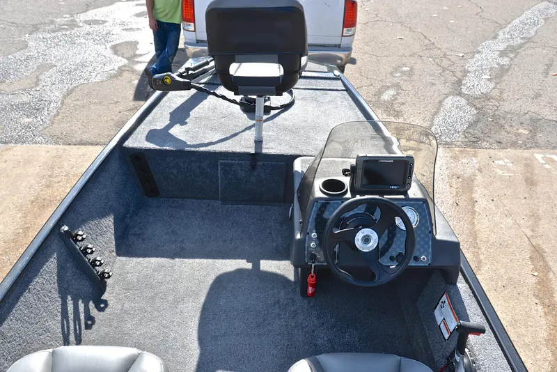 Slide: The Image of 2024 Bass Tracker Classic XL boat interior with steering console and seating. - 22