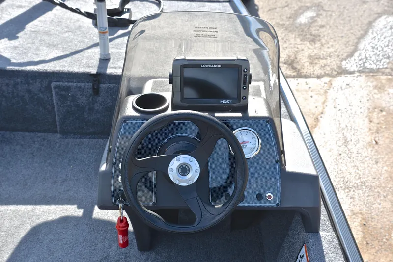 Slide: The Image of 2024 Bass Tracker Classic XL boat dashboard with steering wheel and navigation display. - 23