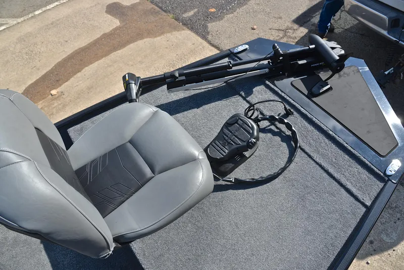 Slide: The Image of 2024 Bass Tracker Classic XL boat interior with gray seat and trolling motor. - 24