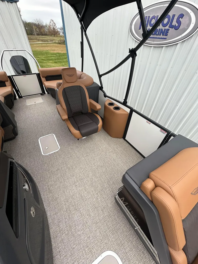 Slide: The Image of 2025 Bennington M26 boat interior with tan and gray seating, spacious layout. - 5