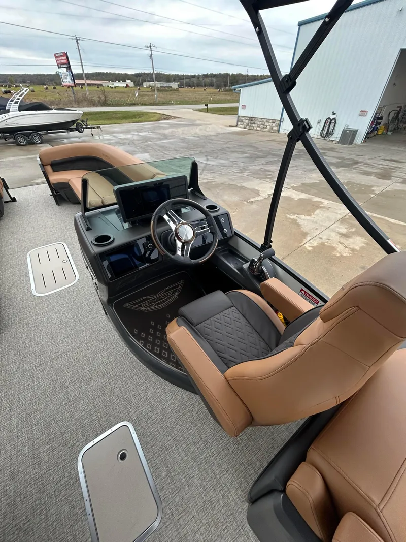 Slide: The Image of 2025 Bennington M26 boat interior with modern helm and tan seating. - 6