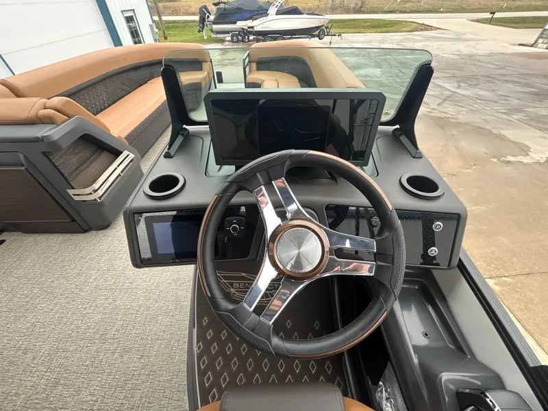 Slide: The Image of 2025 Bennington M26 boat dashboard with modern steering wheel and digital displays. - 7
