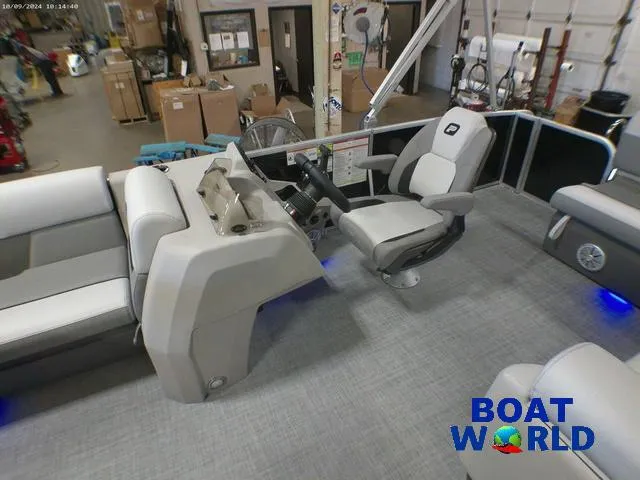 Slide: The Image of 2025 Princecraft Vectra 23 RL pontoon interior with lounge seating and helm, showcased at Boat World. - 11