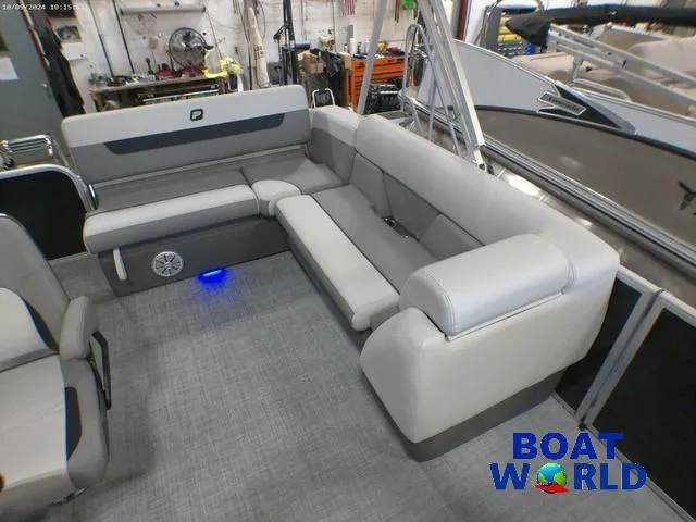Slide: The Image of 2025 Princecraft Vectra 23 RL pontoon with spacious lounge seating in a showroom. - 22